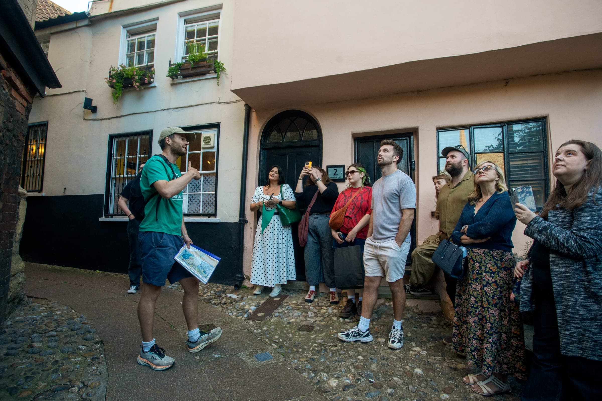 Guide telling a story to a tour group in Tombland